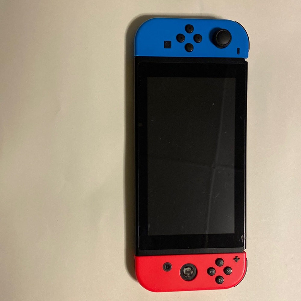 Nintendo switch Used comes with dock and cable and a charge station for controls